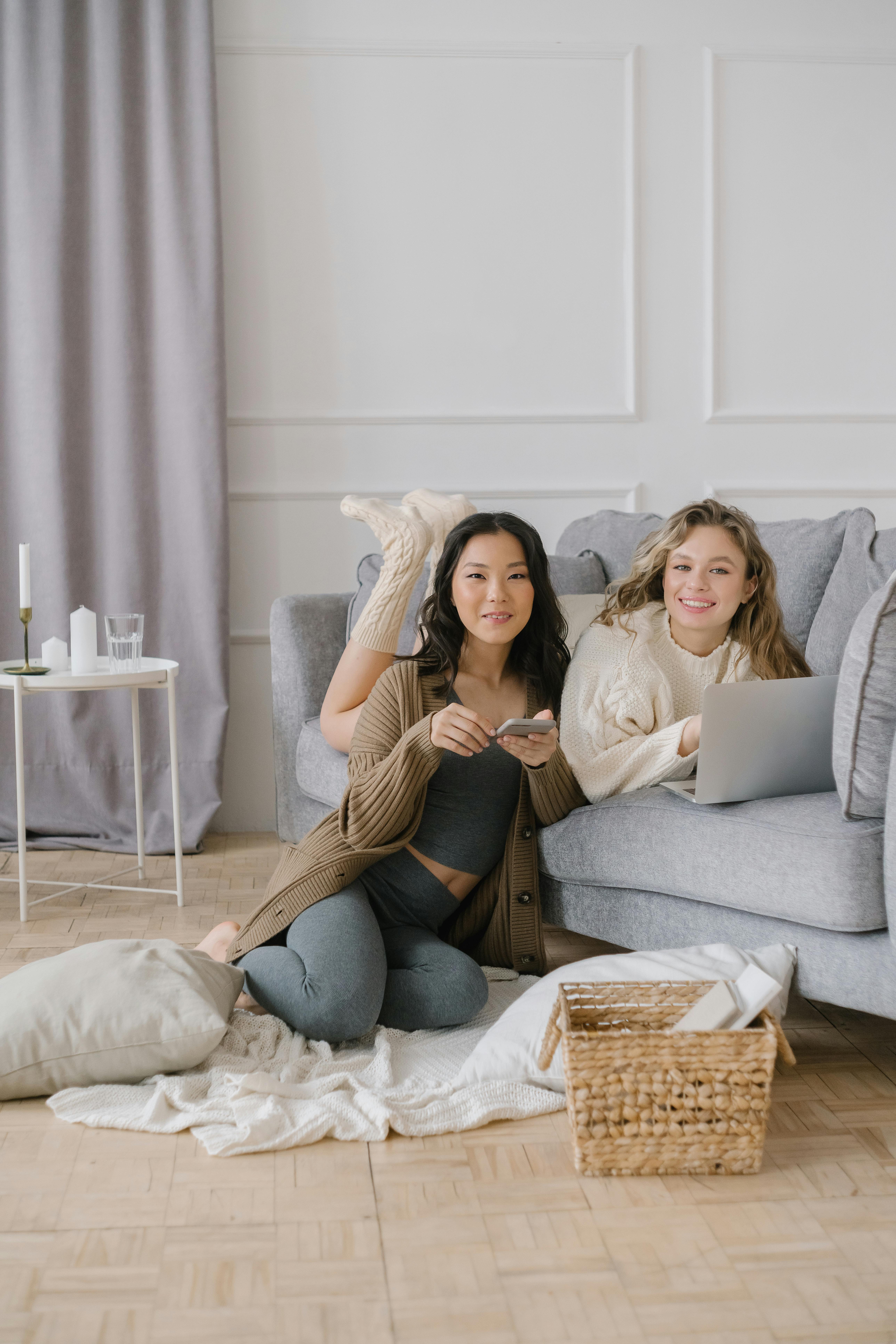 A person smiling gently while working in a calm, cozy home office.